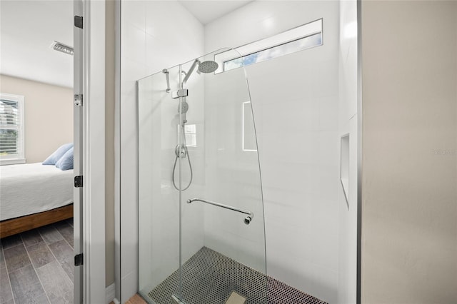 ensuite bathroom with ensuite bath, a shower stall, and wood tiled floor