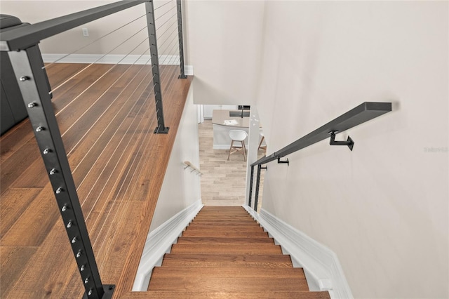 stairway with wood finished floors