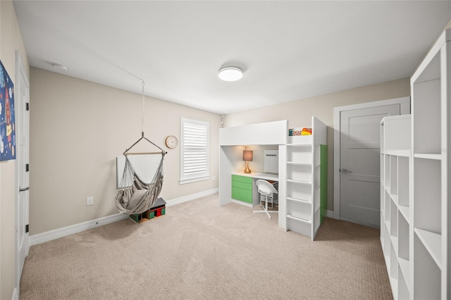 unfurnished bedroom featuring light carpet and baseboards