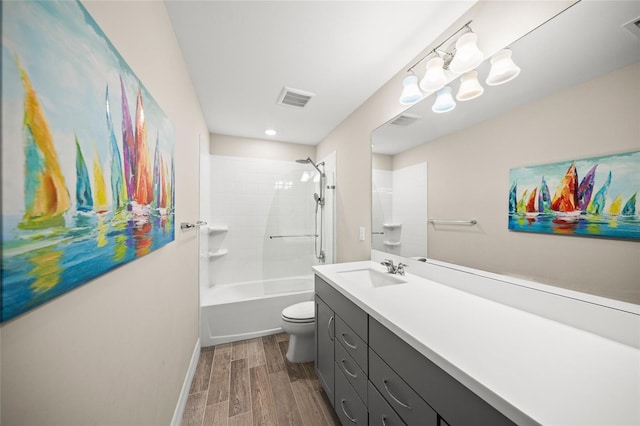 bathroom with shower / bath combination, visible vents, toilet, wood finished floors, and vanity