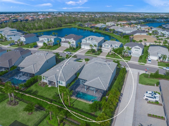 birds eye view of property with a water view and a residential view