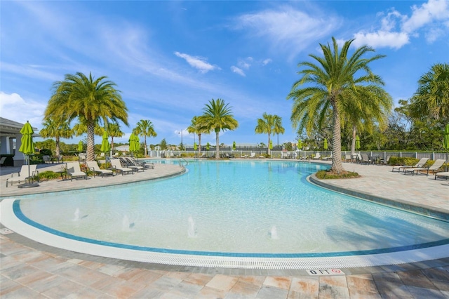 community pool featuring a patio area and fence