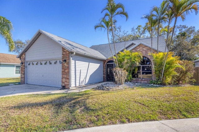 single story home featuring a front yard, concrete driveway, brick siding, and an attached garage