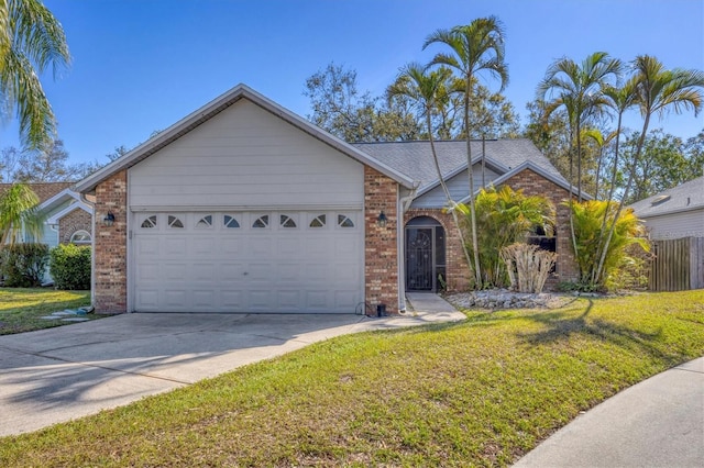 ranch-style house featuring driveway, an attached garage, a front yard, and brick siding