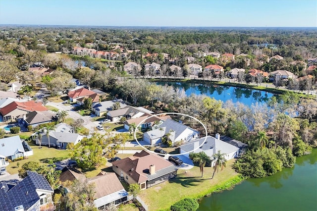 birds eye view of property with a water view and a residential view