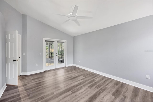 spare room with vaulted ceiling, french doors, wood finished floors, and baseboards