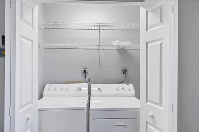 clothes washing area with laundry area and washer and dryer