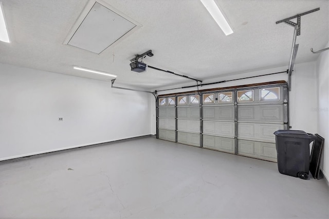 garage with a garage door opener and baseboards