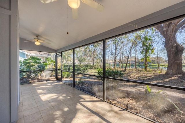 unfurnished sunroom with lofted ceiling, plenty of natural light, and a ceiling fan