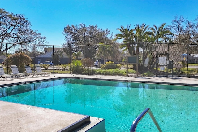 pool with fence and a patio