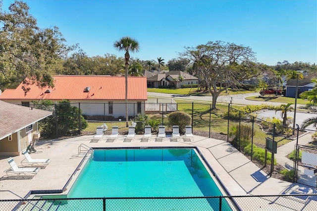 pool with a residential view, fence, and a patio