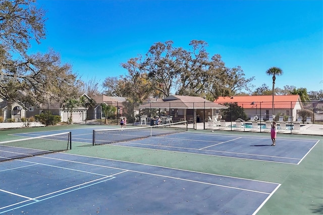 view of tennis court featuring fence