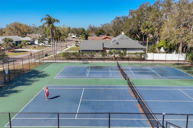 view of sport court featuring fence