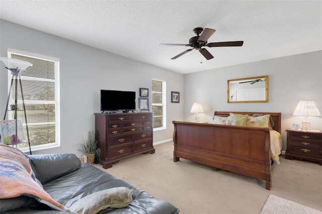 carpeted bedroom with a textured ceiling and ceiling fan