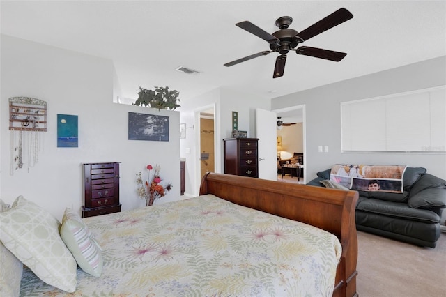 bedroom featuring carpet flooring, ceiling fan, visible vents, and ensuite bath