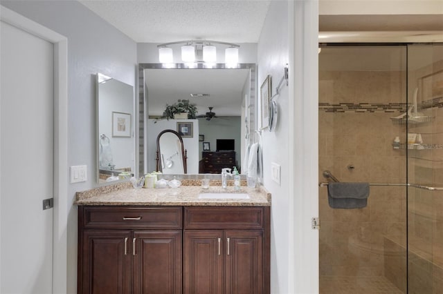 full bathroom featuring a textured ceiling, ensuite bath, a shower stall, and vanity