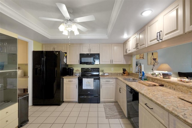 kitchen featuring a tray ceiling, ornamental molding, light tile patterned flooring, a sink, and black appliances