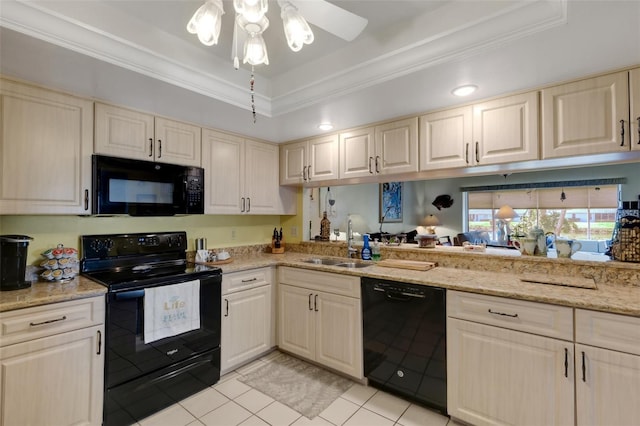 kitchen featuring a tray ceiling, light tile patterned floors, ornamental molding, a sink, and black appliances