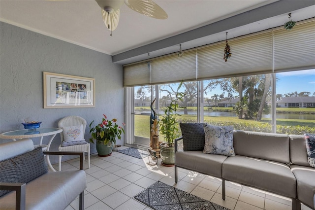 sunroom / solarium featuring a ceiling fan and a water view