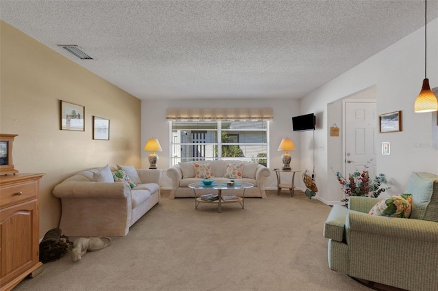 living room with light carpet, a textured ceiling, and visible vents