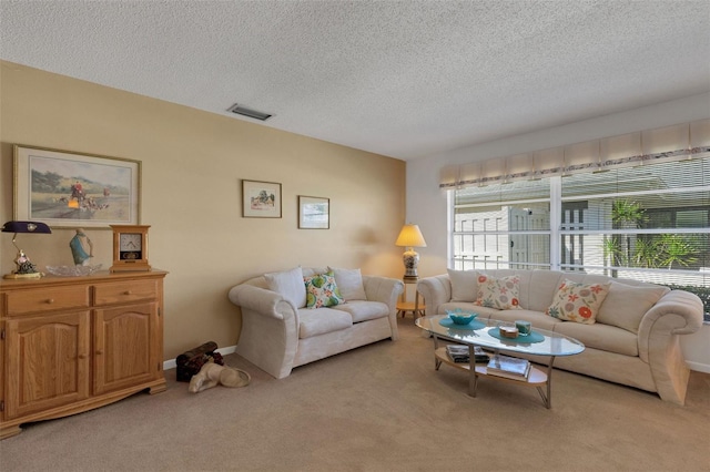 living area featuring a textured ceiling, baseboards, visible vents, and light colored carpet