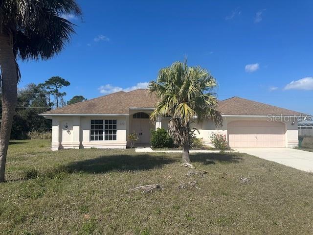 single story home with driveway, a front yard, an attached garage, and stucco siding