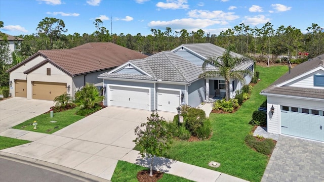 single story home with a tile roof, stucco siding, an attached garage, driveway, and a front lawn