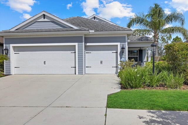 ranch-style home featuring a garage and concrete driveway