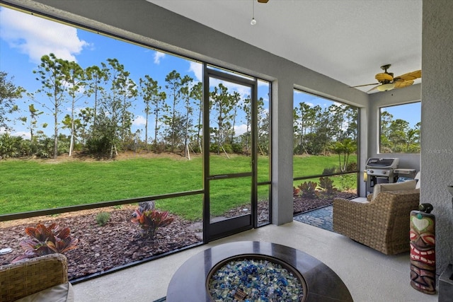 sunroom featuring ceiling fan