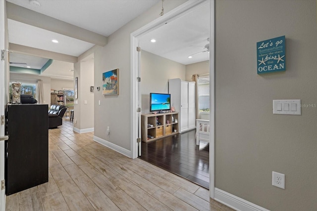 corridor featuring a wealth of natural light, baseboards, wood finished floors, and recessed lighting