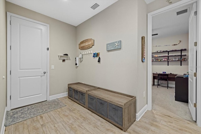 mudroom with wood finished floors, visible vents, and baseboards