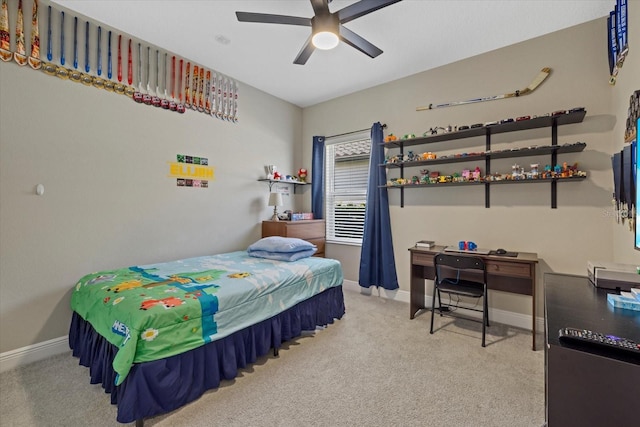 carpeted bedroom featuring baseboards and a ceiling fan