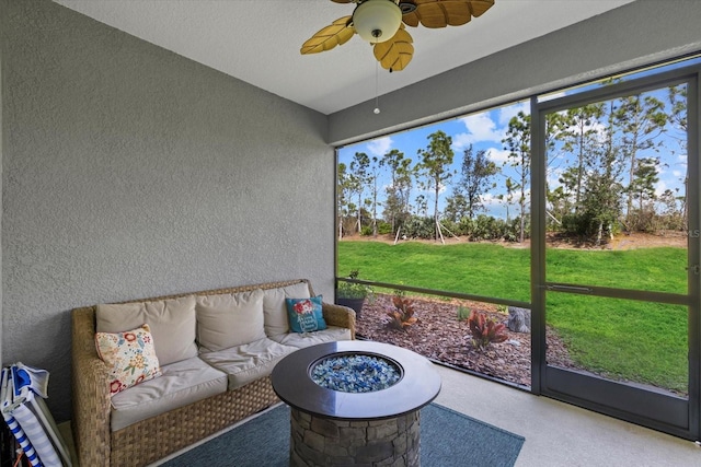 sunroom / solarium featuring a ceiling fan