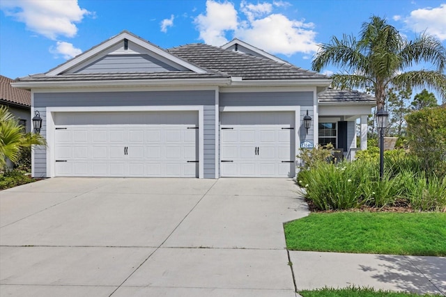 ranch-style house with a garage and driveway