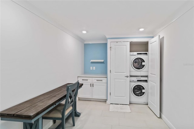 laundry area featuring laundry area, stacked washer and dryer, baseboards, ornamental molding, and recessed lighting