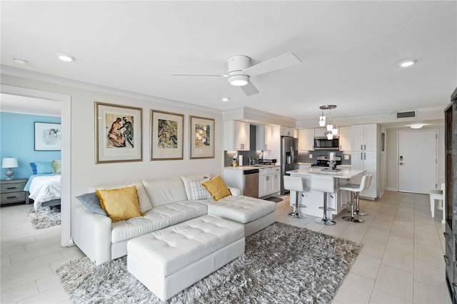 living area featuring a ceiling fan, visible vents, crown molding, and light tile patterned floors