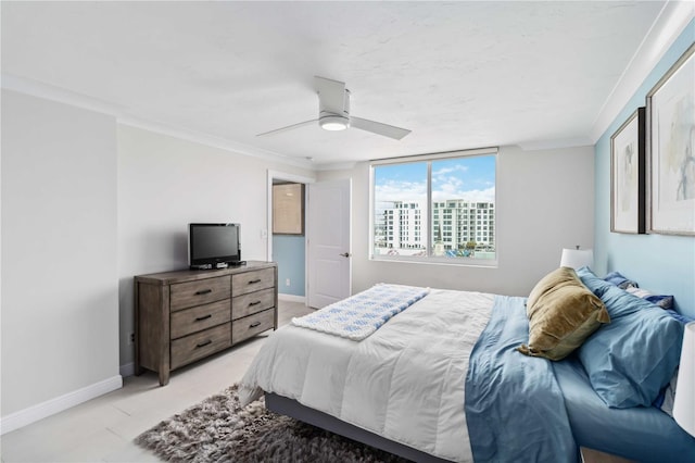 bedroom featuring crown molding, a ceiling fan, and baseboards