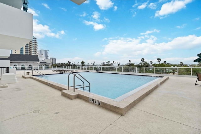 view of pool featuring a view of city