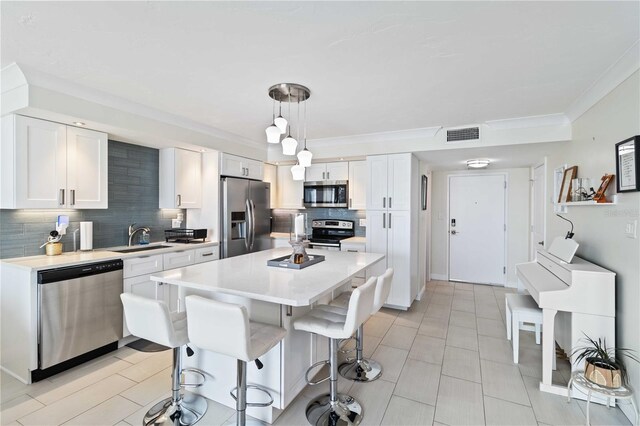 kitchen featuring visible vents, white cabinets, appliances with stainless steel finishes, light countertops, and a sink