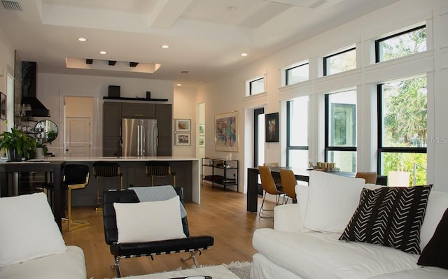 living room with light wood-style floors, visible vents, and recessed lighting