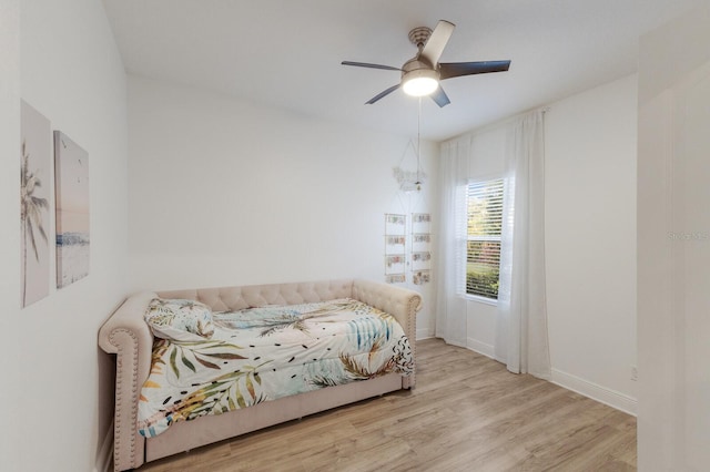 bedroom featuring wood finished floors, a ceiling fan, and baseboards