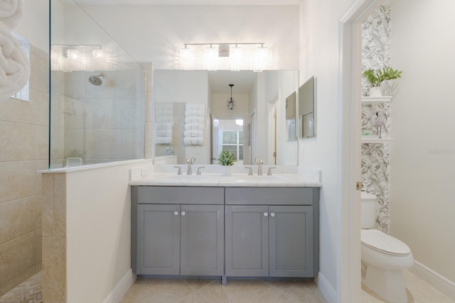 bathroom with double vanity, toilet, a sink, a walk in shower, and tile patterned flooring