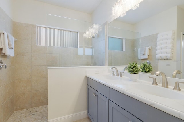 bathroom featuring double vanity, a sink, and walk in shower