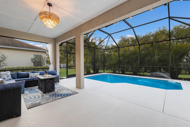 outdoor pool with a patio area, glass enclosure, and an outdoor living space with a fire pit