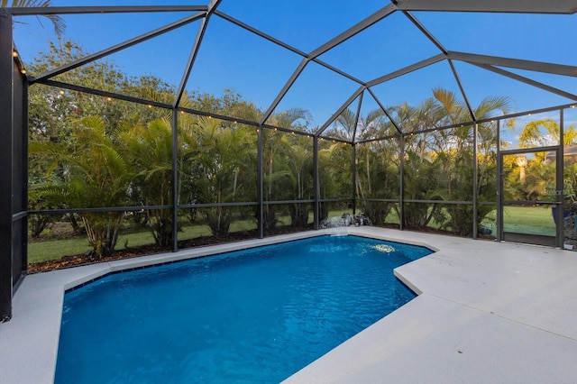 pool with a lanai and a patio area