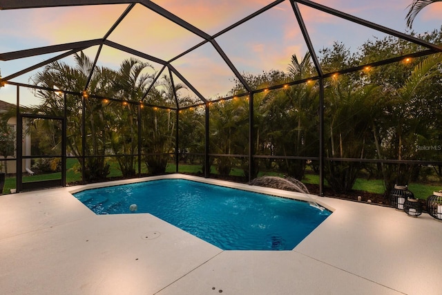 pool with a lanai and a patio area