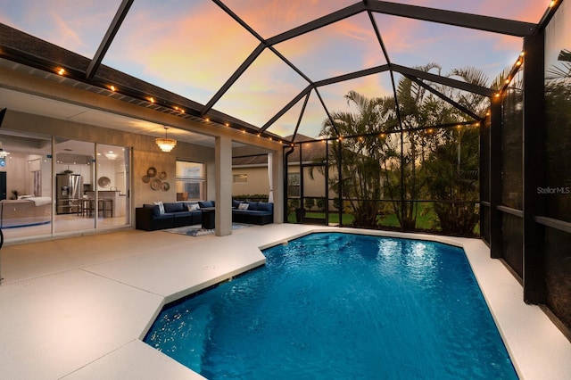 outdoor pool featuring a lanai, a patio area, and an outdoor hangout area