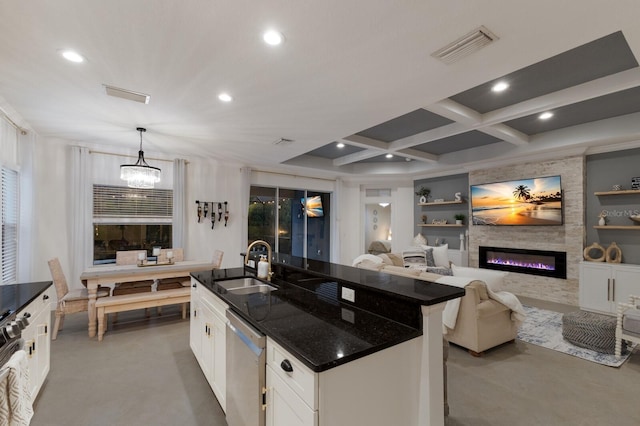 kitchen featuring built in shelves, a large fireplace, a sink, visible vents, and stainless steel dishwasher