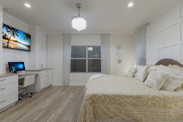 bedroom with light wood-type flooring, recessed lighting, ornamental molding, and built in study area