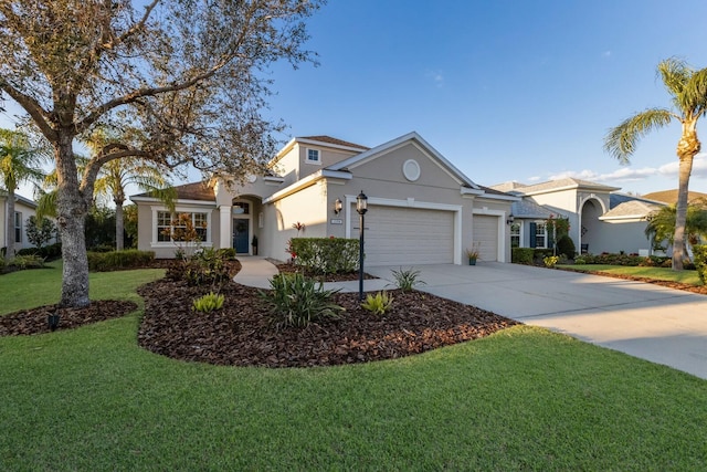 view of front of house featuring a front yard, driveway, an attached garage, and stucco siding